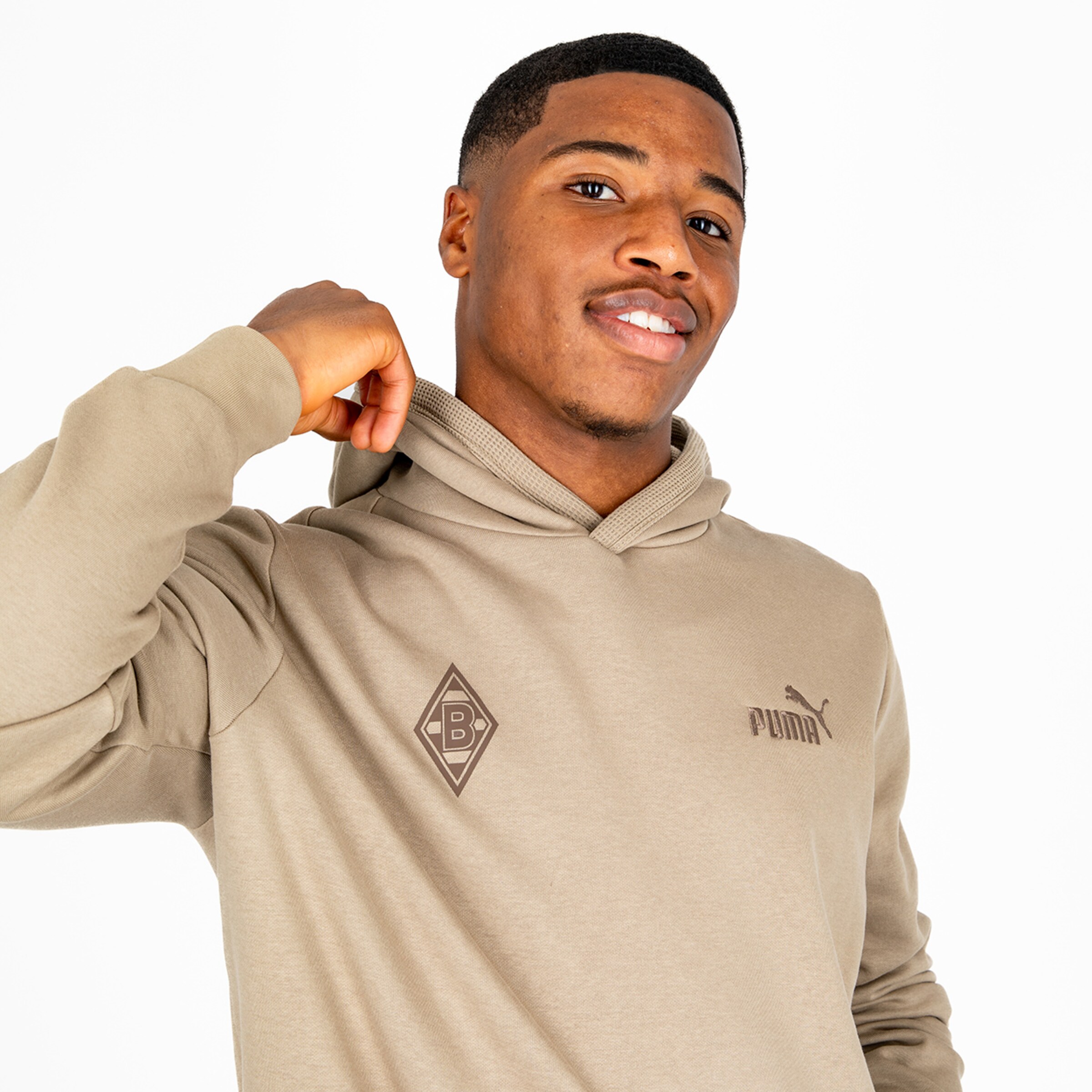 Young man wearing a hoodie with the Borussia Mönchengladbach logo and Puma branding.