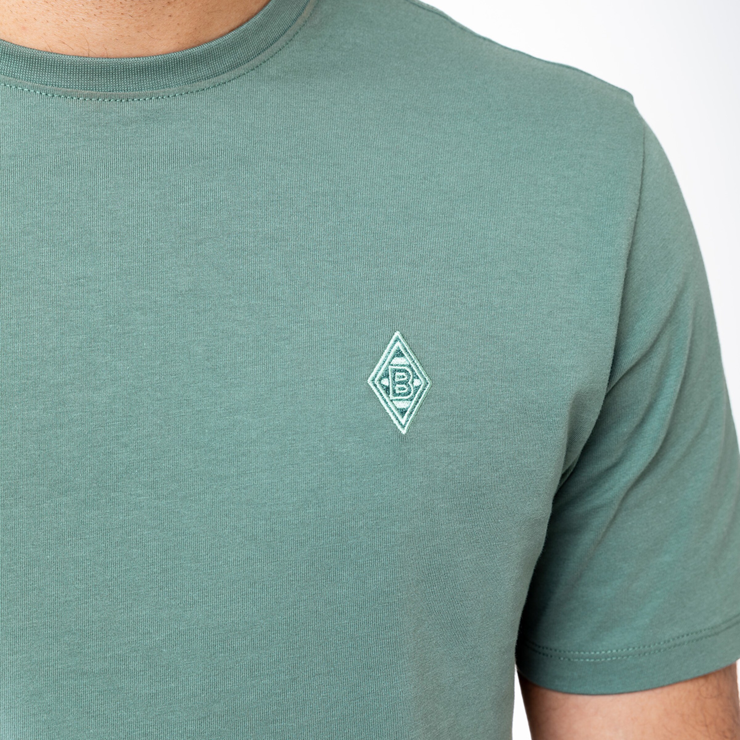 Green T-shirt featuring embroidered Borussia Mönchengladbach logo on the left chest.