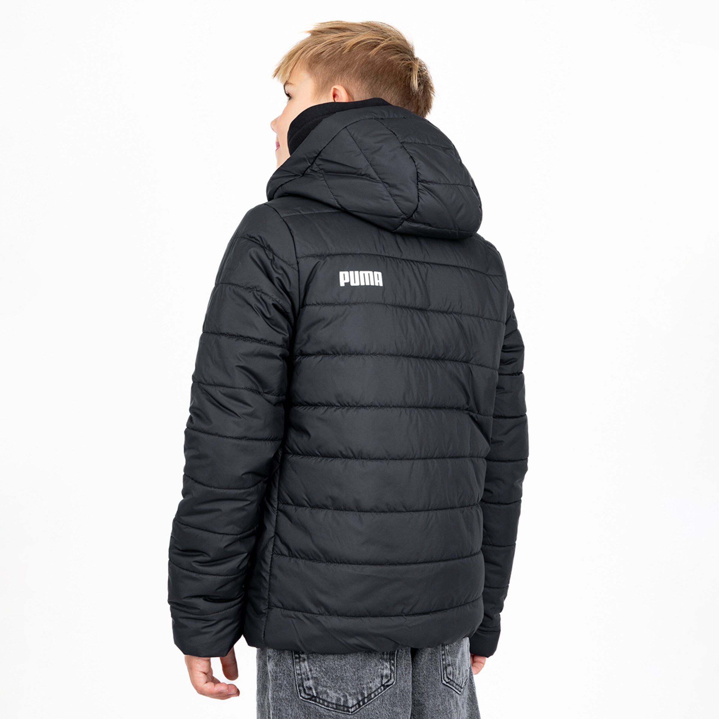 Boy wearing a black padded jacket from Puma.