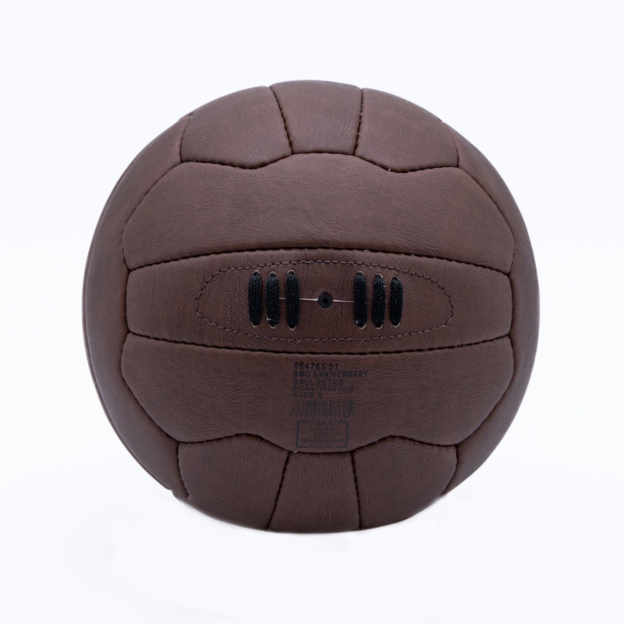 Vintage-style brown leather soccer ball with black laces and printed text, isolated on a white background.