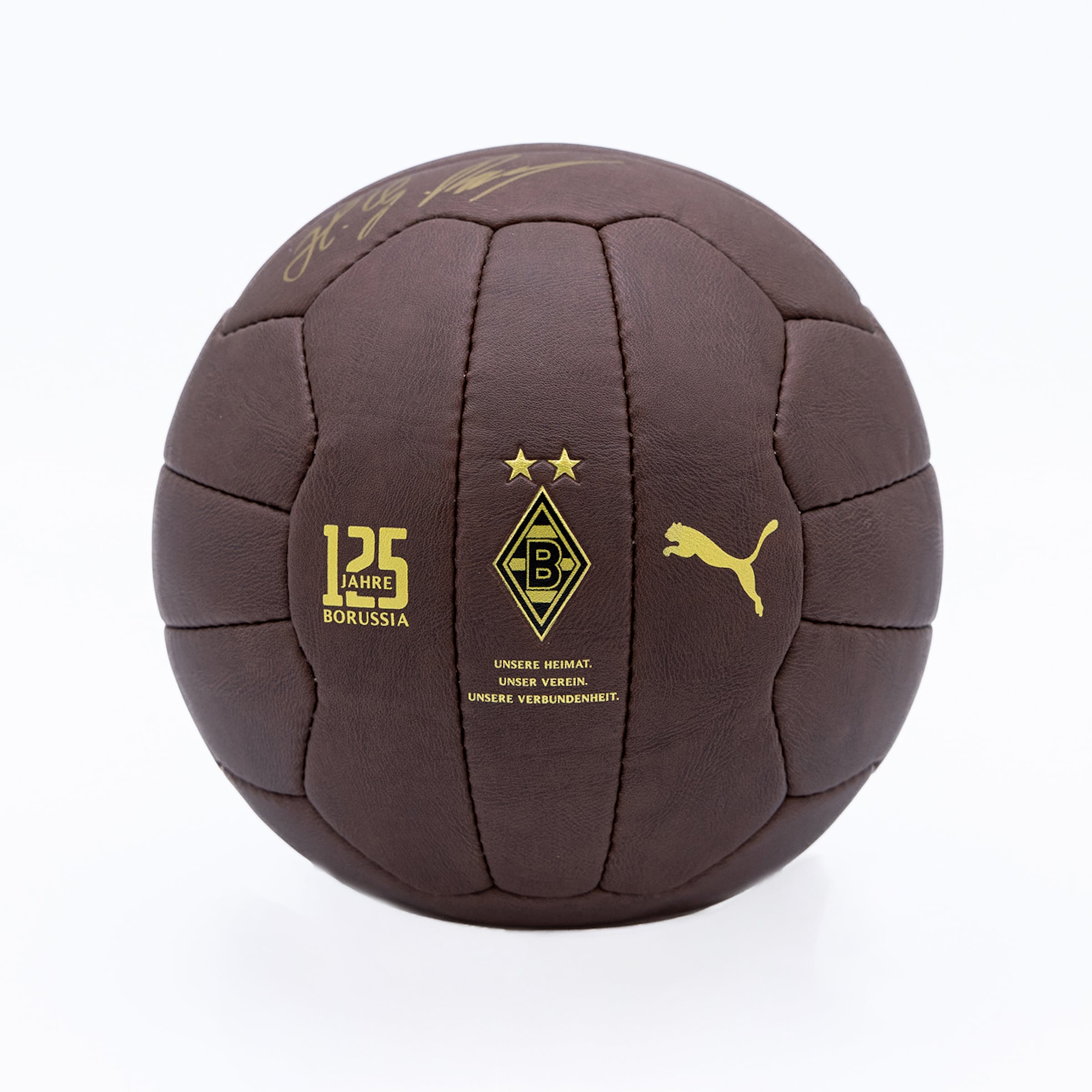 Brown retro football for Borussia Mönchengladbach's 125th anniversary, featuring gold Puma and club logos, motto, and a signature on leather.