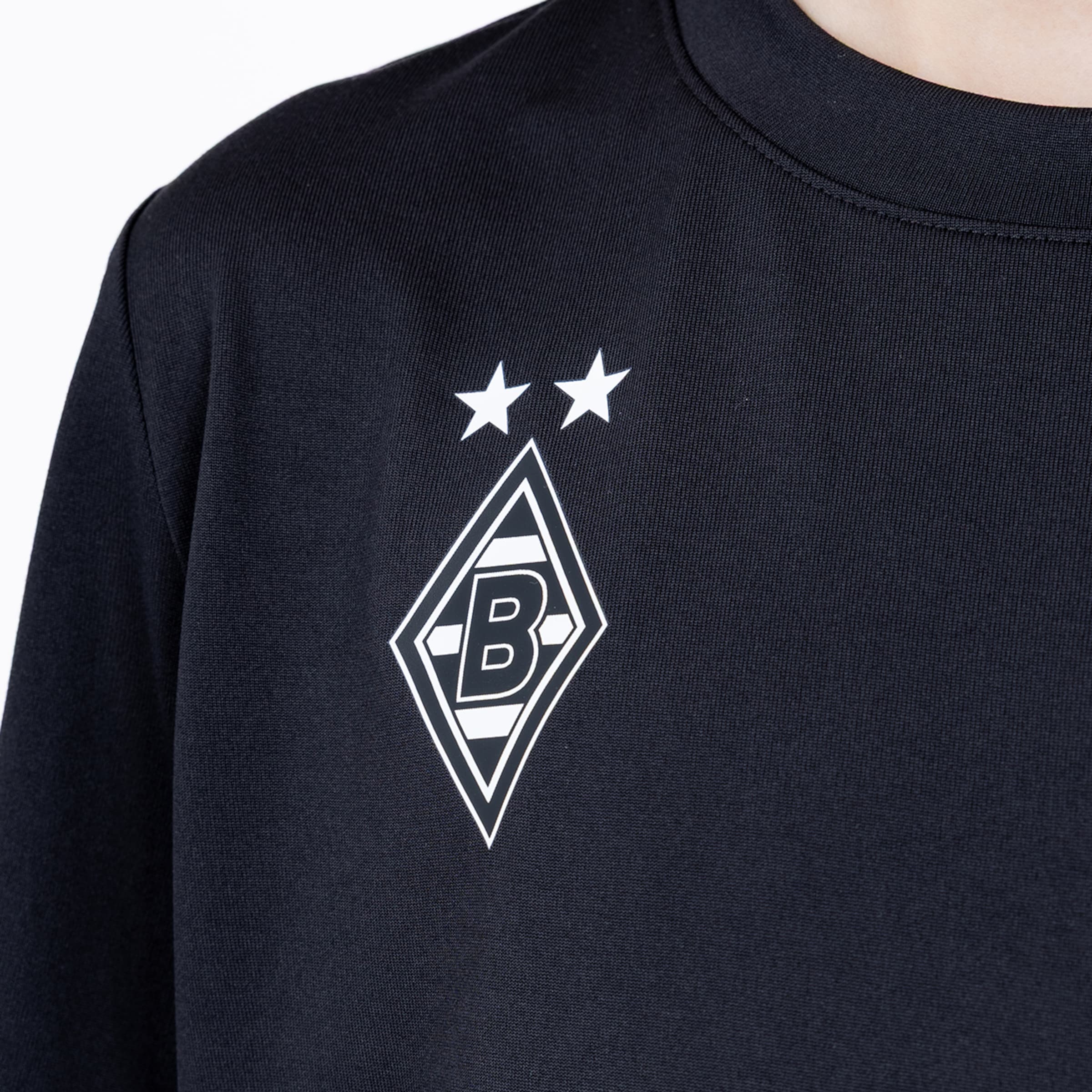 Close-up of a black sweatshirt featuring the white Borussia Mönchengladbach logo and two stars on the left chest area.
