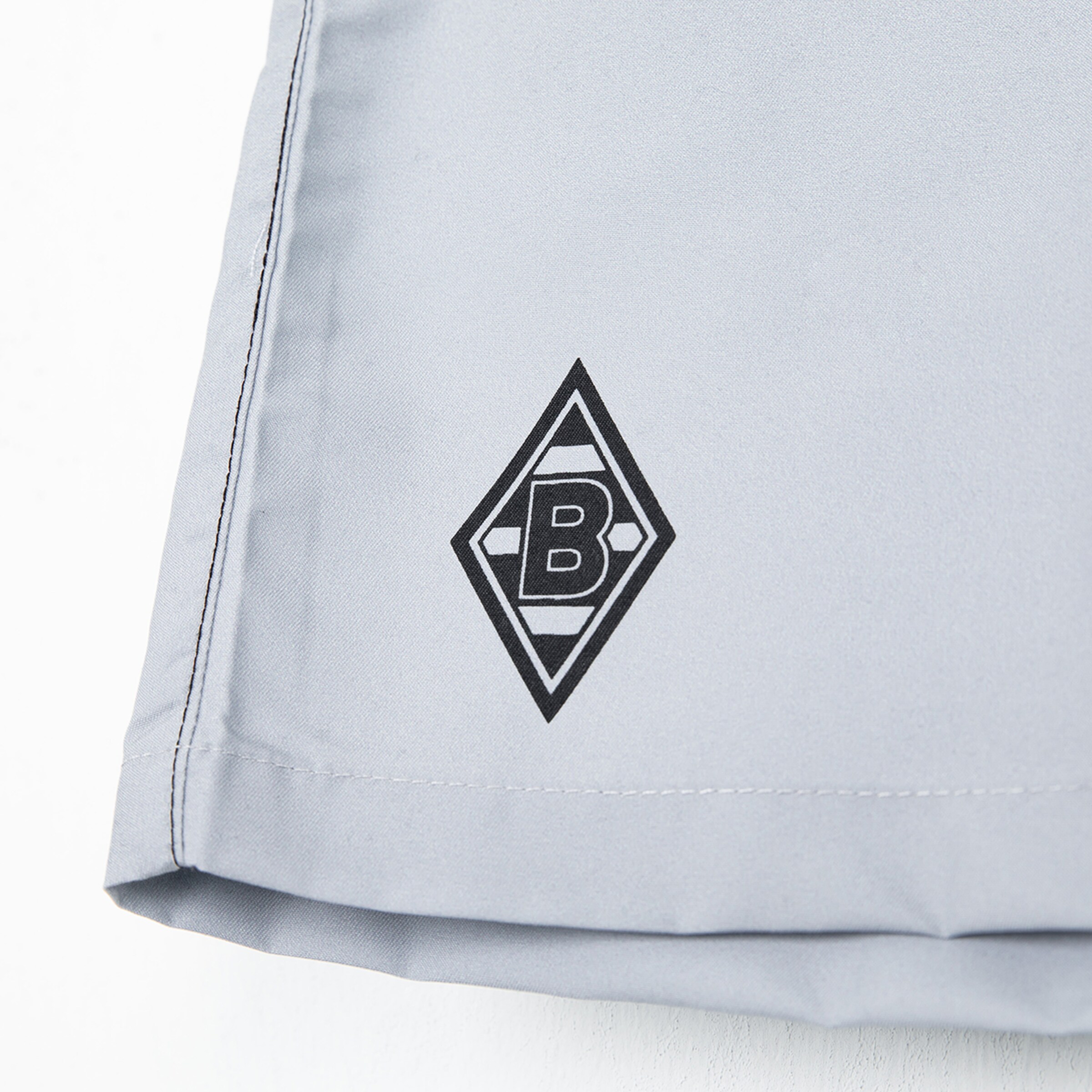 Logo von Borussia Mönchengladbach auf grauem Stoff