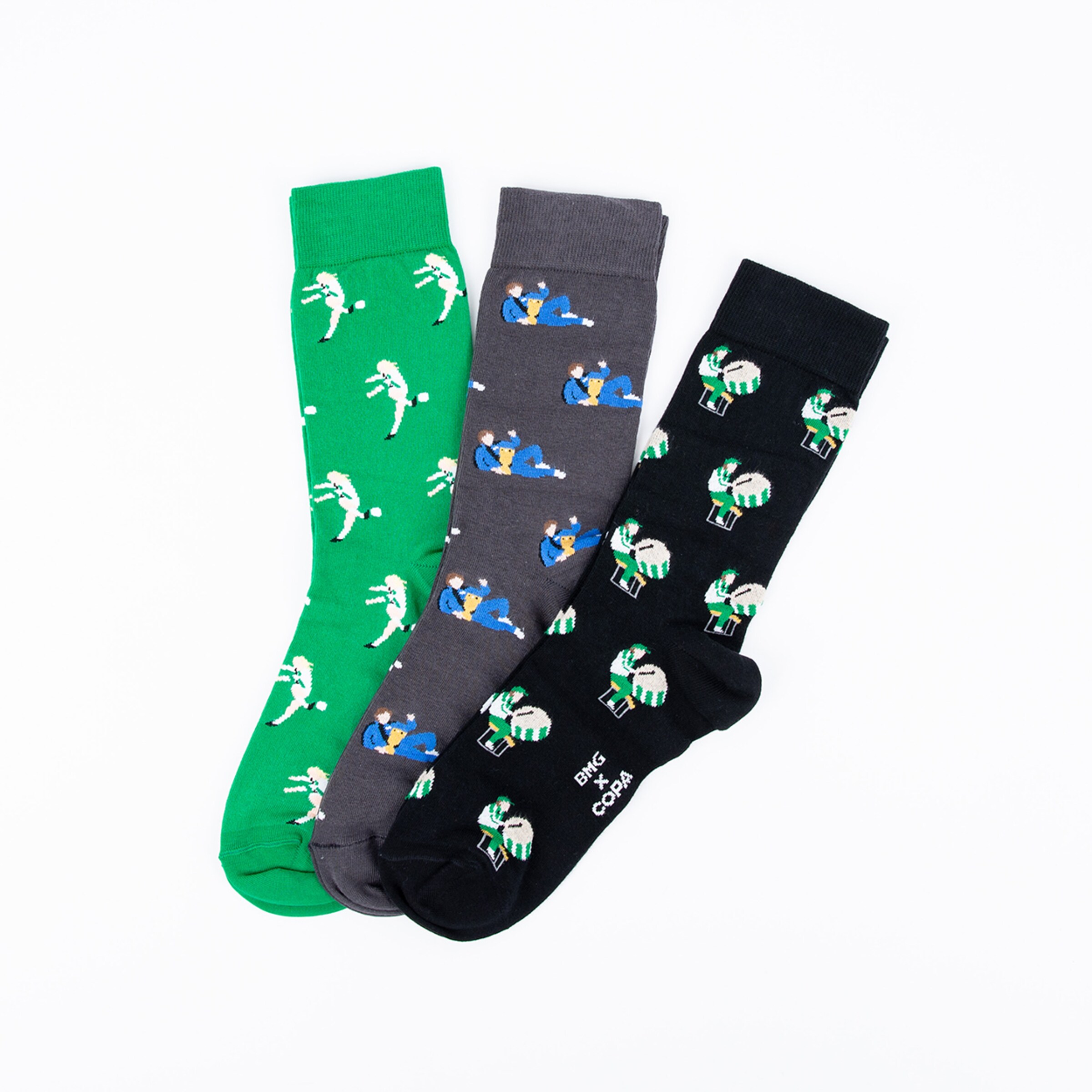 Three pairs of socks featuring soccer motifs: green gray and black socks.