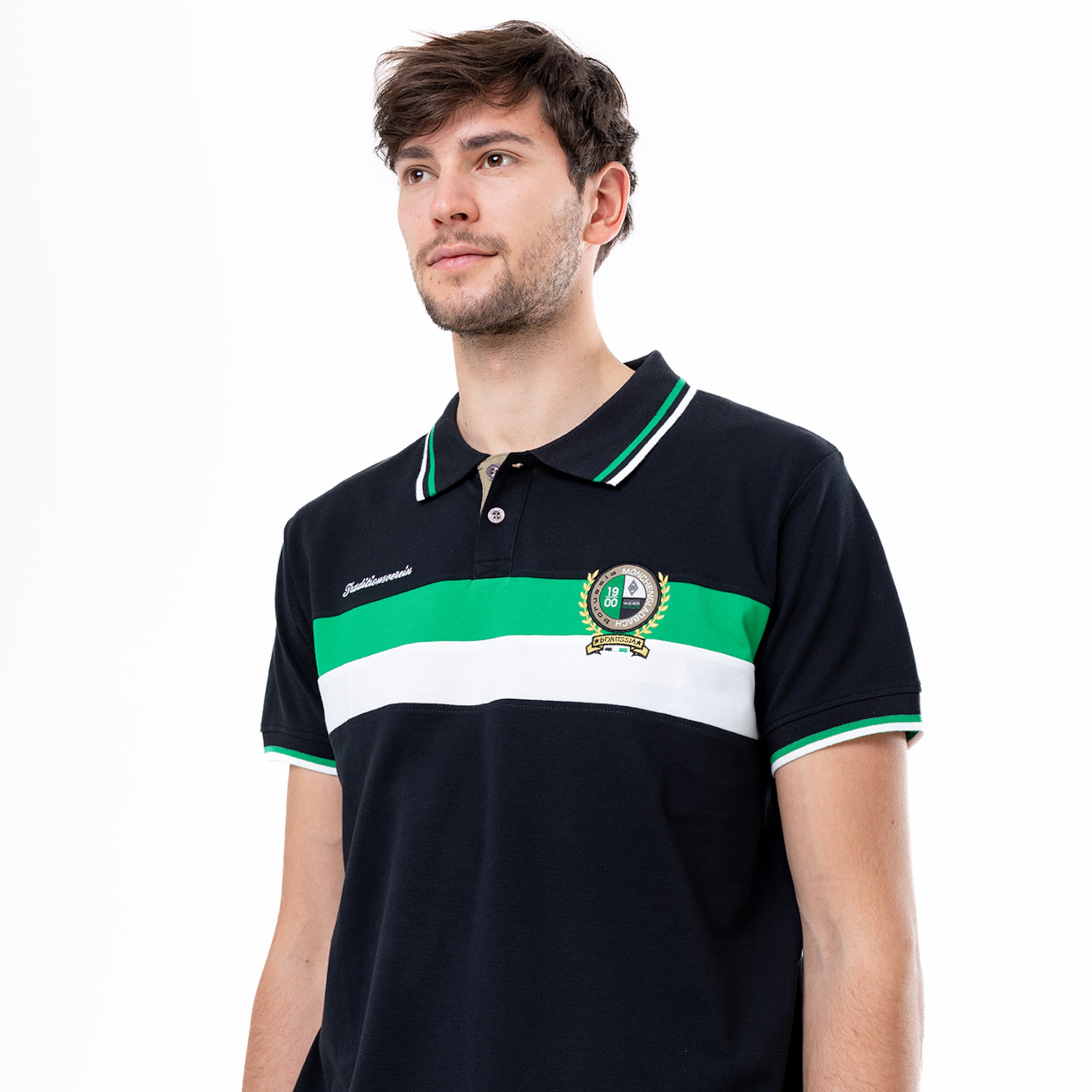 Man in black polo shirt with green and white stripes and Borussia Mönchengladbach logo.