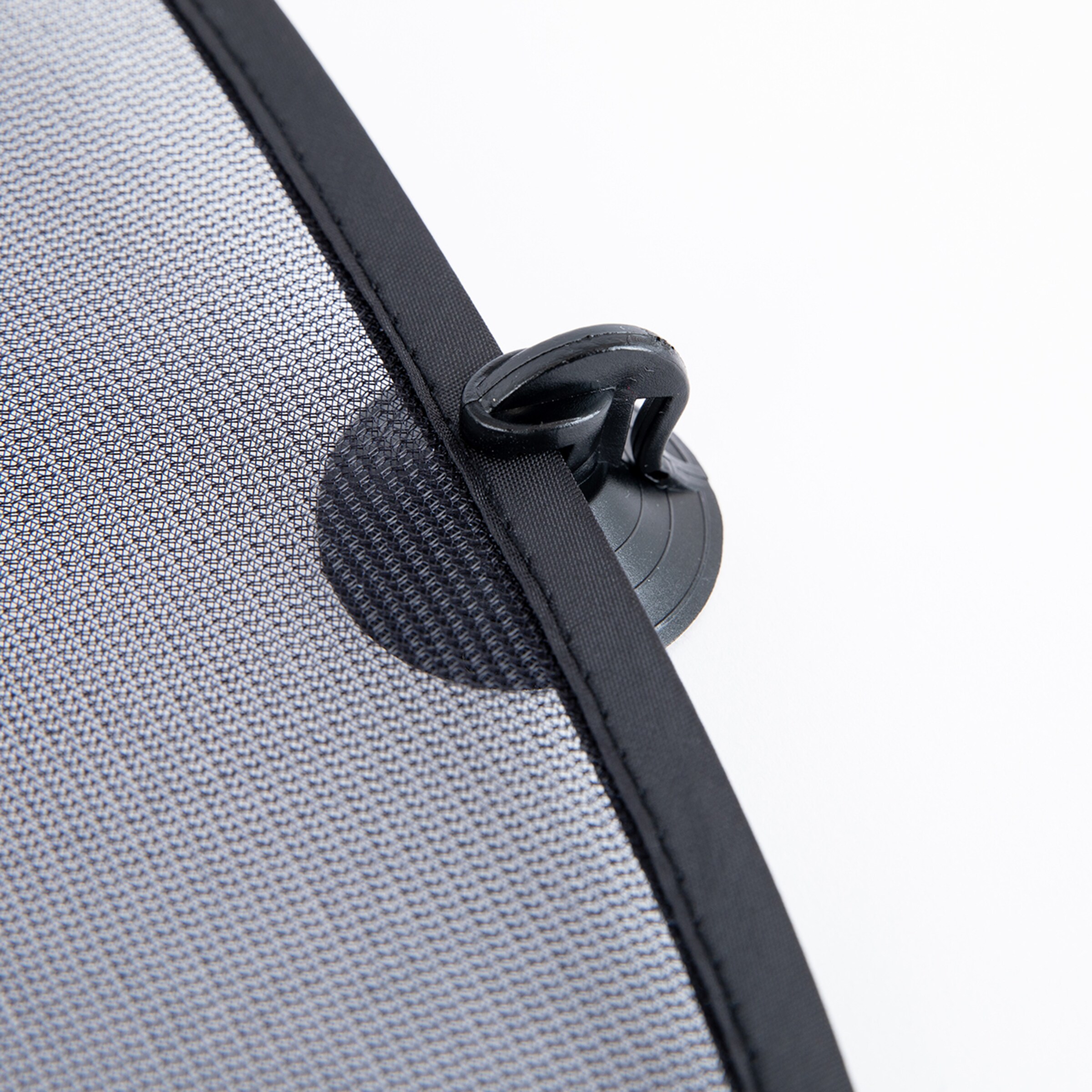 Close-up of a black clip on a mesh element.