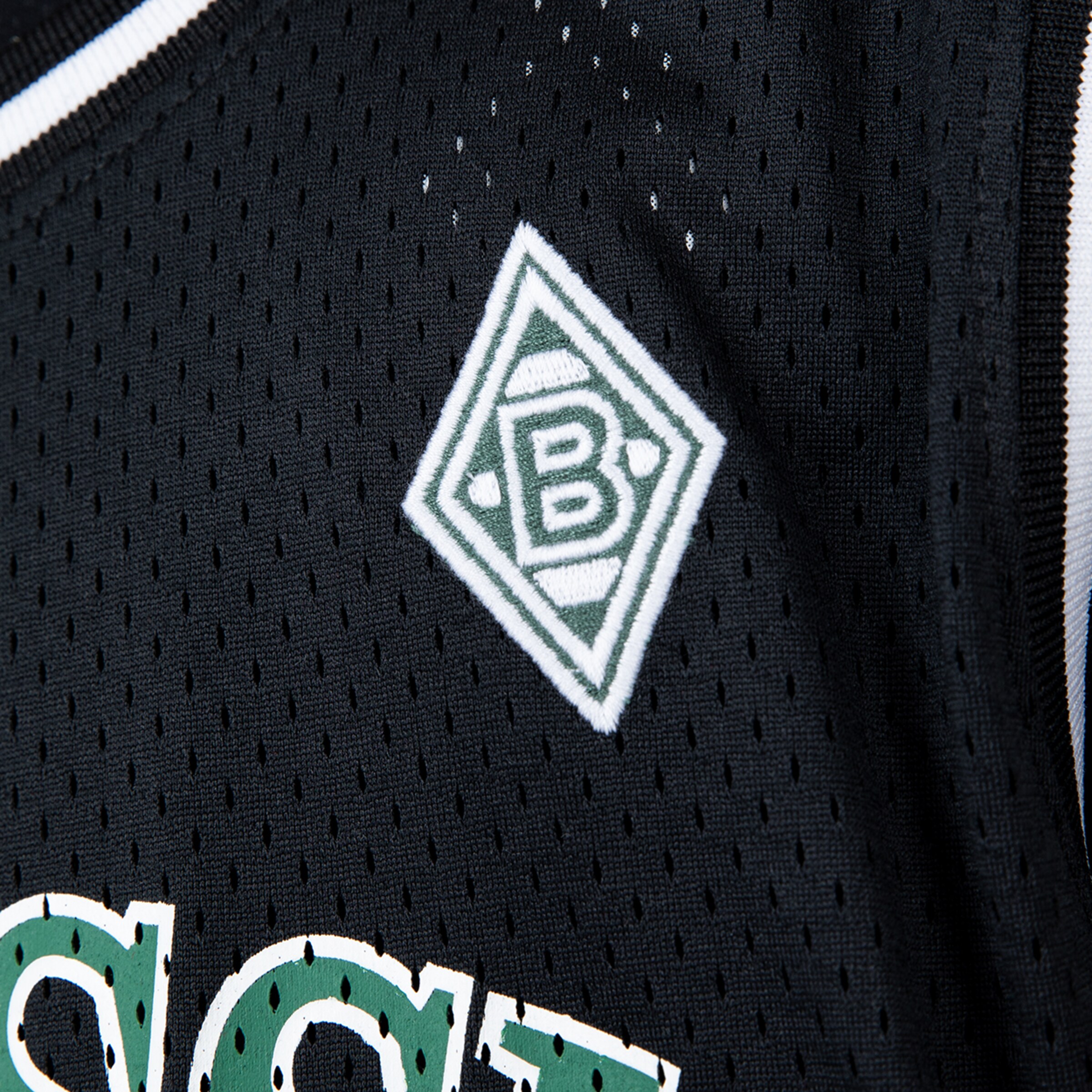 Logo of Borussia Mönchengladbach on a black jersey.