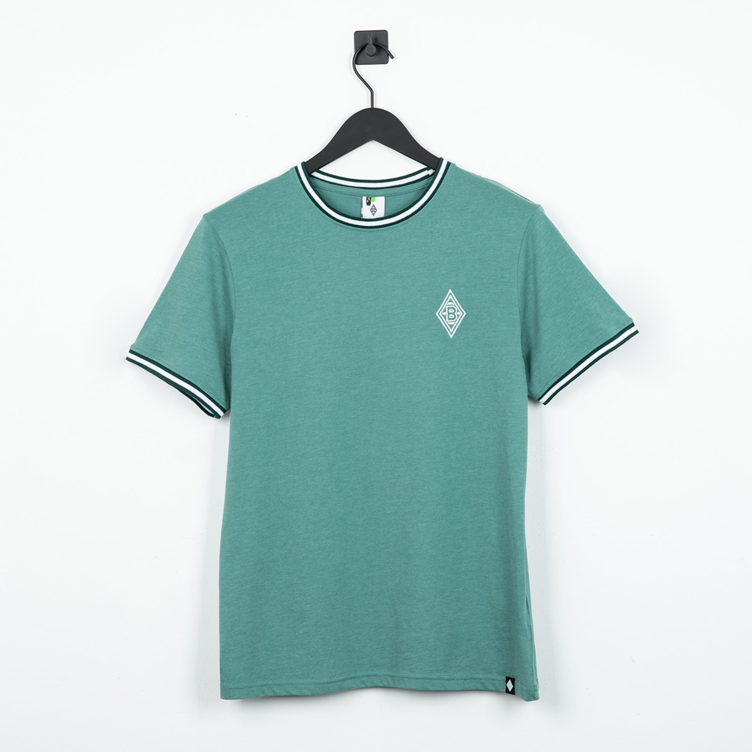 Light green t-shirt with black and white collar featuring a small club logo on the chest.