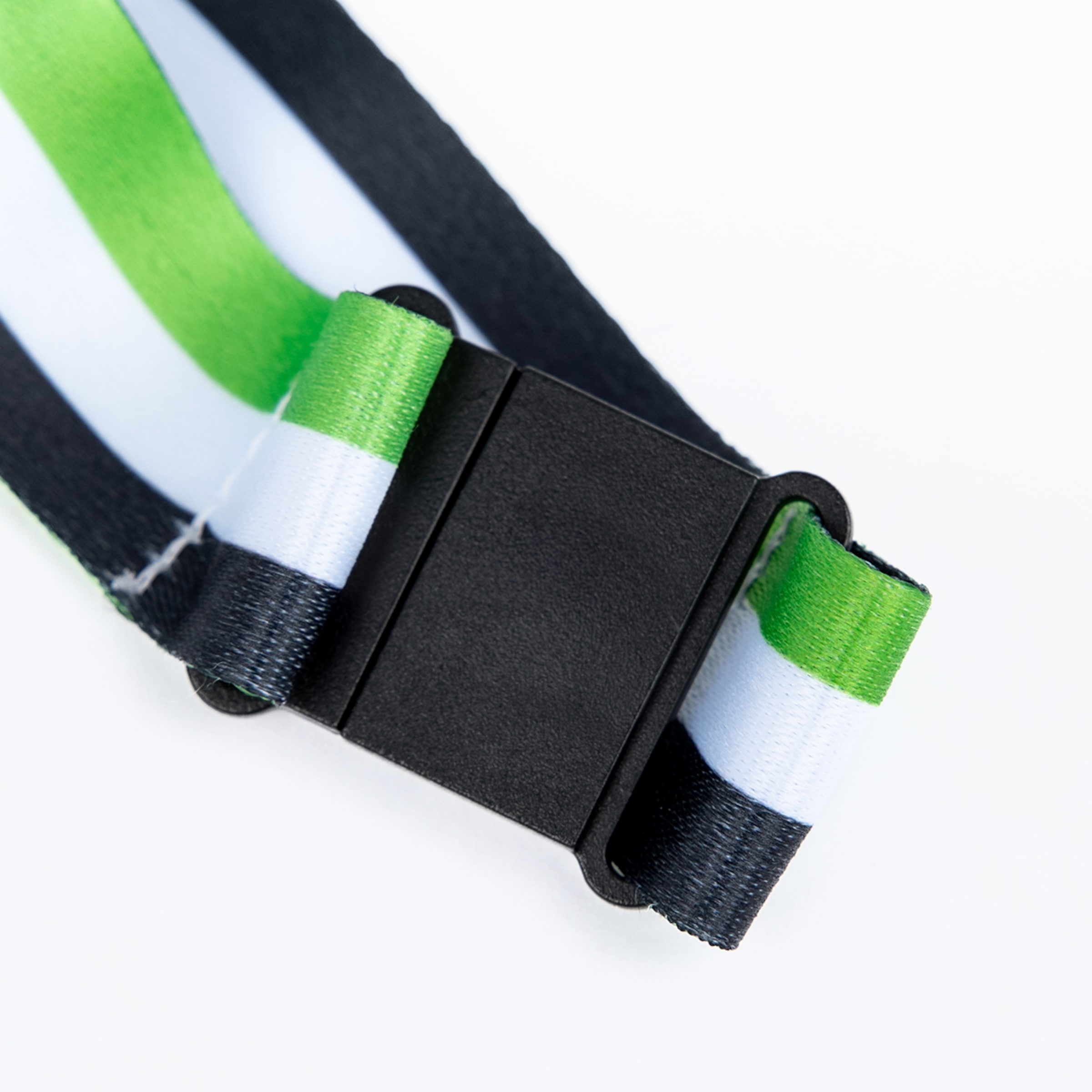 Close-up of a green, white, and black striped strap with a black plastic buckle on a white background.